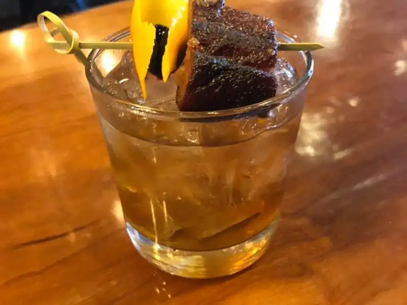 Bourbon cocktail next to BBQ at the bar