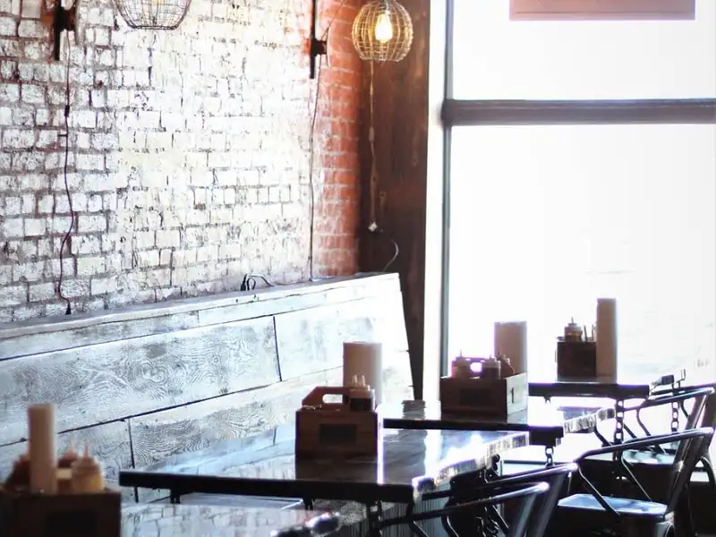 Brick-walled dining room where live music plays at Old Town Smokehouse