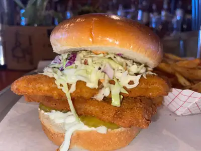 Fried fish sandwich with fries at Old Town Smokehouse