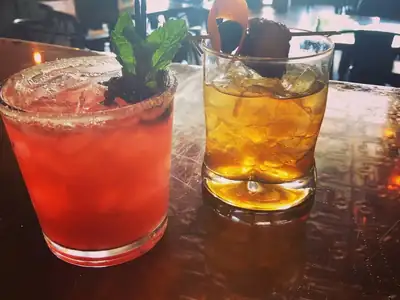 A lineup of colorful handcrafted cocktails on the bar