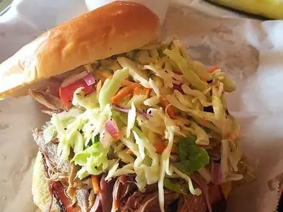 Hawaiian Pork Sandwich piled with pulled pork and coleslaw, with mac and cheese