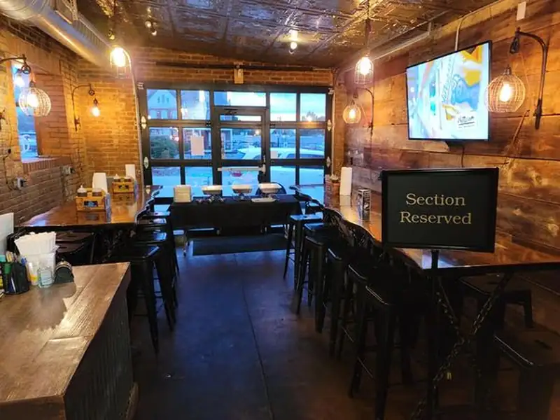 A reserved section of the Old Town Smokehouse dining room set for a private event