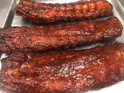 Rack of smoked ribs representing American BBQ styles